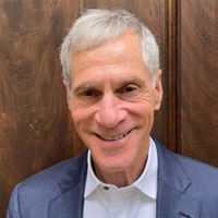 grey hair man with blue jacket