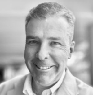Black and white photograph of man smiling