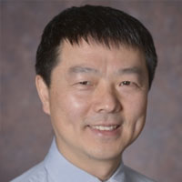 Man with short hair and blue shirt
