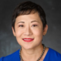 Woman with blue jacket and short black hair